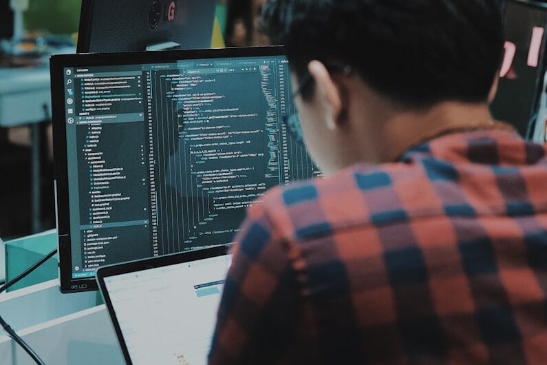 sitting man using gadget in room
